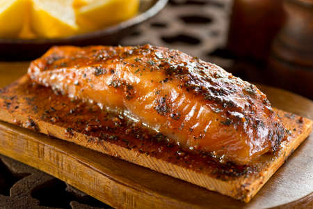 A single serving portion of delicious cedar smoked salmon.の写真素材