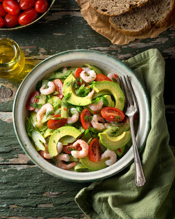 A delicious coldwater shrimp and avocado salad with tomato, cucumber, celery, green onion, cilantro, and dill.の写真素材