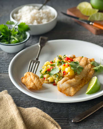 Delicious sauteed fish with pineapple jalapeno salsa and lime.の写真素材