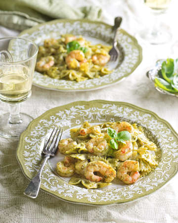 Delicious home made farfalle pasta with shrimp and basil pesto.の写真素材