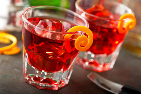 Delicious negroni cocktails with campari, gin, vermouth, and a citrus orange twist.の写真素材