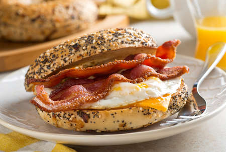 A delicious breakfast bagel with bacon, egg and cheese.の写真素材