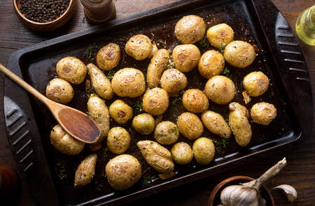 Delicious homemade herb and garlic roasted baby potatoes.の写真素材