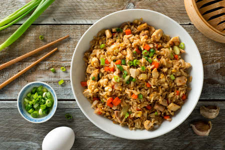 Delicious chicken fried rice with egg, carrot, garlic and green onion.の写真素材