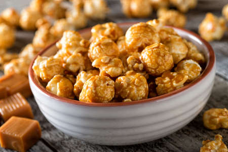 A bowl of delicious homemade caramel coated popcorn.の写真素材