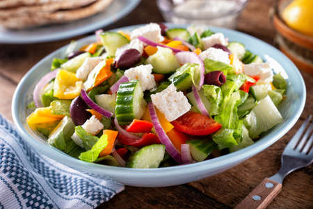 A bowl of delicious homemade greek salad with pita bread.の写真素材