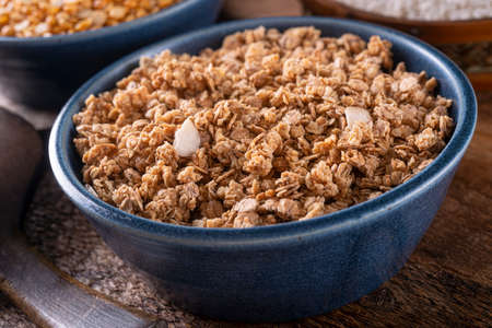 A bowl of delicious homemade dry granola with almonds.の写真素材