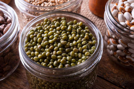 Green mung beans in a glass storage container.の写真素材