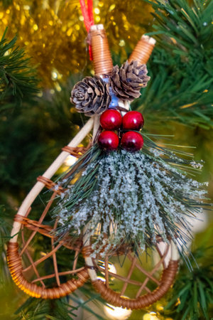 Snowshoes Christmas ornament in an artificial christmas tree with Christmas lights in backgroundの写真素材