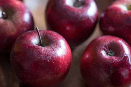 Apples very red and bright, appetizing, on a tableの写真素材