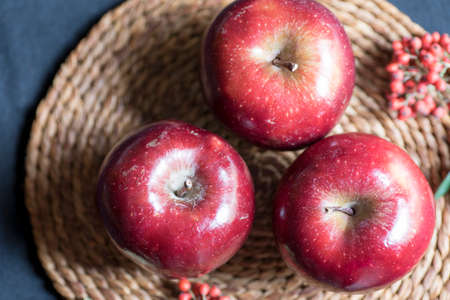 Apples very red and bright, appetizing, on a tableの写真素材