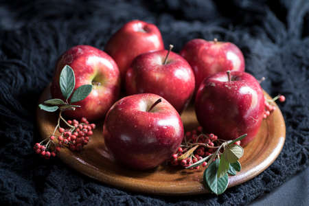 Apples very red and bright, appetizing, on a tableの写真素材