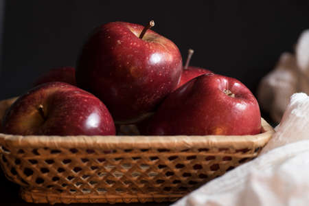 Apples very red and bright, appetizing, on a tableの写真素材