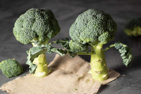 raw broccoli bouquet, on a piece of burlap and on a table