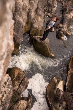 Young man posing in the field and with a bridge in the background. Enjoying the outdoorsの写真素材