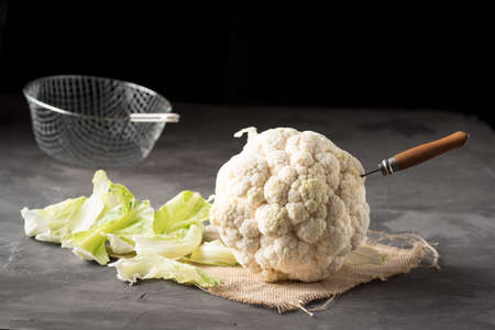 Raw cauliflower on a table ready to be cleaned and cooked. Tasty vegetables