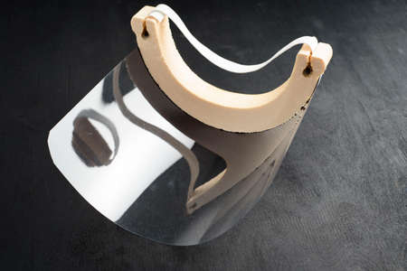 Transparent face screen, on black background. Protector to prevent contagionの写真素材