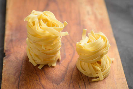 pasta nest of wheat flour, on a wooden board