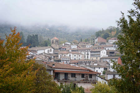 View between the trees and foggy Candelario, Salamanca, Castilla Leon, Spain, Europe.の写真素材