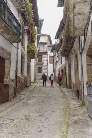 Three people walking and sightseeing through the narrow streets of Candelario, Salamanca, Castilla Leon, Spain, Europe.のeditorial素材