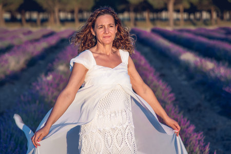 A Woman dressed in white in a lavender fieldの写真素材