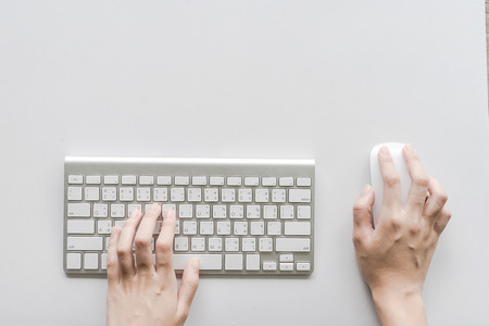 Woman typing on computer keyboard, Low light, selective focus on hand, can be used for e-commerce, business, technology and internet concept, Vintage tone filterの写真素材