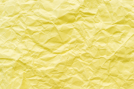 crumpled yellow paper texture backgroundの写真素材