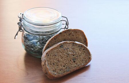 Pumpkin seed on table with two slice of breadの写真素材