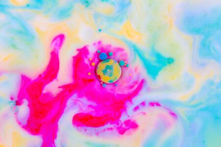 Abstract background, red and blue color mix together in milk. Macro photoの写真素材