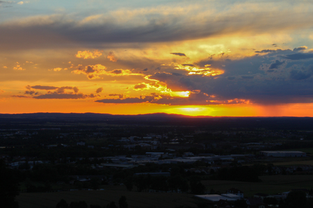 Panoramatic view on city Ceske Budejovice in sunset with orange skyの写真素材