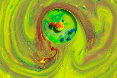 Mixing abstract colors in milk with green and red colors