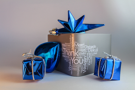Grey gift box with text and blue decoration on grey backgroundの写真素材