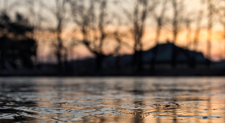 Ice on pond in sunrise with blured backgroundの写真素材