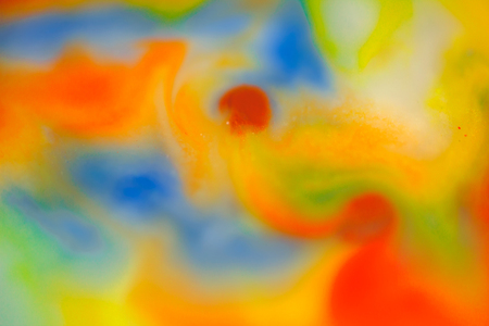 Watercolor mix in milk, color macro abstract. Water drops, oil drops, milk drops, paint drops in green and red colorの写真素材