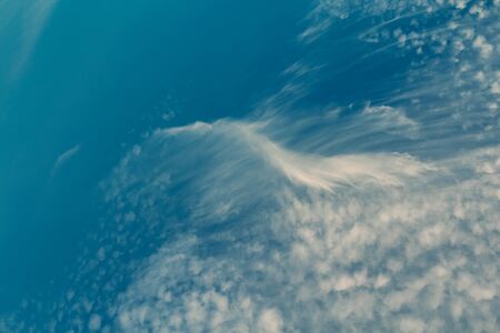 Amazing white cumulus clouds shape made by wind on blue sky
