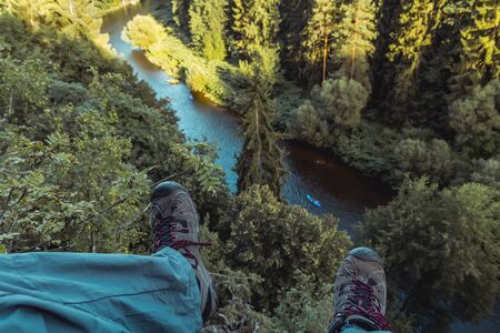 Detail of boots in nice summer valley with Vltava river and boat, Czech republicの写真素材