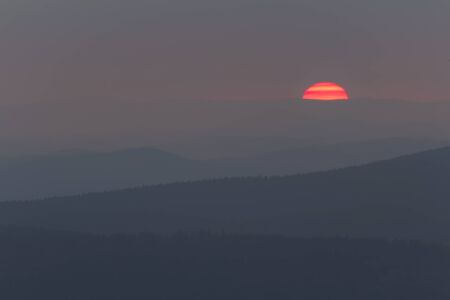 Detail of sunset with distant hill from Tristolicnik. Outdoor and landscape background. Sumava National Park and Bavarian Forest, Czech republic and Germanyの写真素材