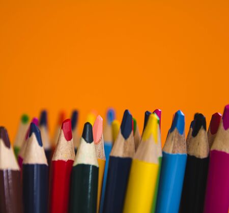 Group of wood color pencil on orange backgroundの写真素材