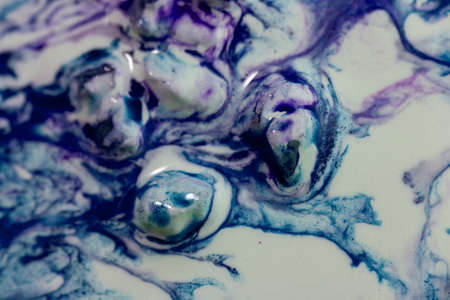 Luqiud vivid blue and violet color mixing together on white background. Painting, splash marble...