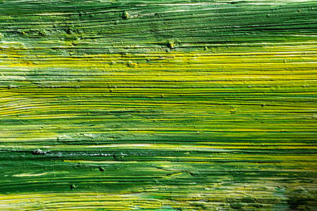 Oil green and yellow color brush stroke macro photo. Painting texture backgroundの写真素材