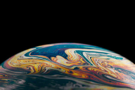 Macro colorful abstract soap bubble on black backgroundの写真素材