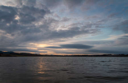 Amazing dramatic sunset sky with cumulus cloud on pond Dehtar. Czech landscapeの写真素材