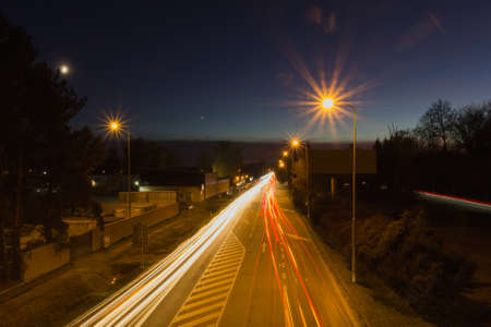 Long exposure car light trail on asphalt road with night sky. Traffic concept, Ceske Budejovice, Czech republicの写真素材