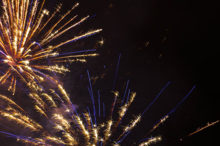 Happy new year fireworks at night in city Ceske Budejovice. Shiny glitter pyrotechnics on black...