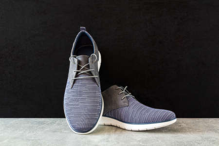 Casual man shoe, boots on marble texture with black background. Studio photoの写真素材