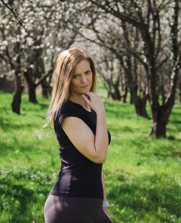 Portrait of young beauty Caucasian woman in cherry blossom tree. People, spring conceptの写真素材