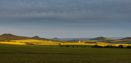Ceske stredohori, north Czech hill landscape at dramatic sunset light. Nature, weather panoramic...