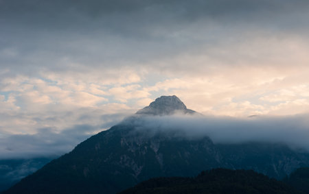 Alps mountain top in fog cloud. Travel lifestyle copy space background, Austria landscapeの写真素材