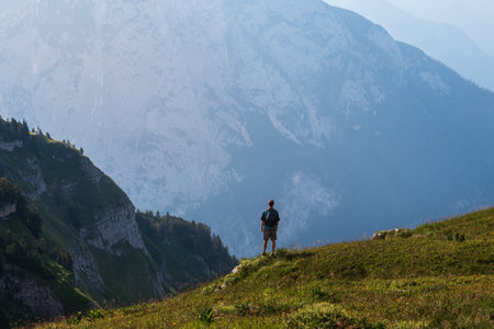 Man, tourist with backpack standing above mountain valley. Loser, Austria alpsの写真素材