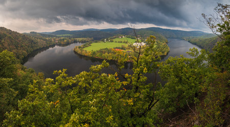 Panoramic view to Vltava river horseshoe meander on Slapy dam under storm sky. Czech autumn landscapeの写真素材